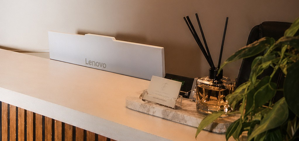 The Sauna Sanctuary reception desk beneath the illuminated logo sign