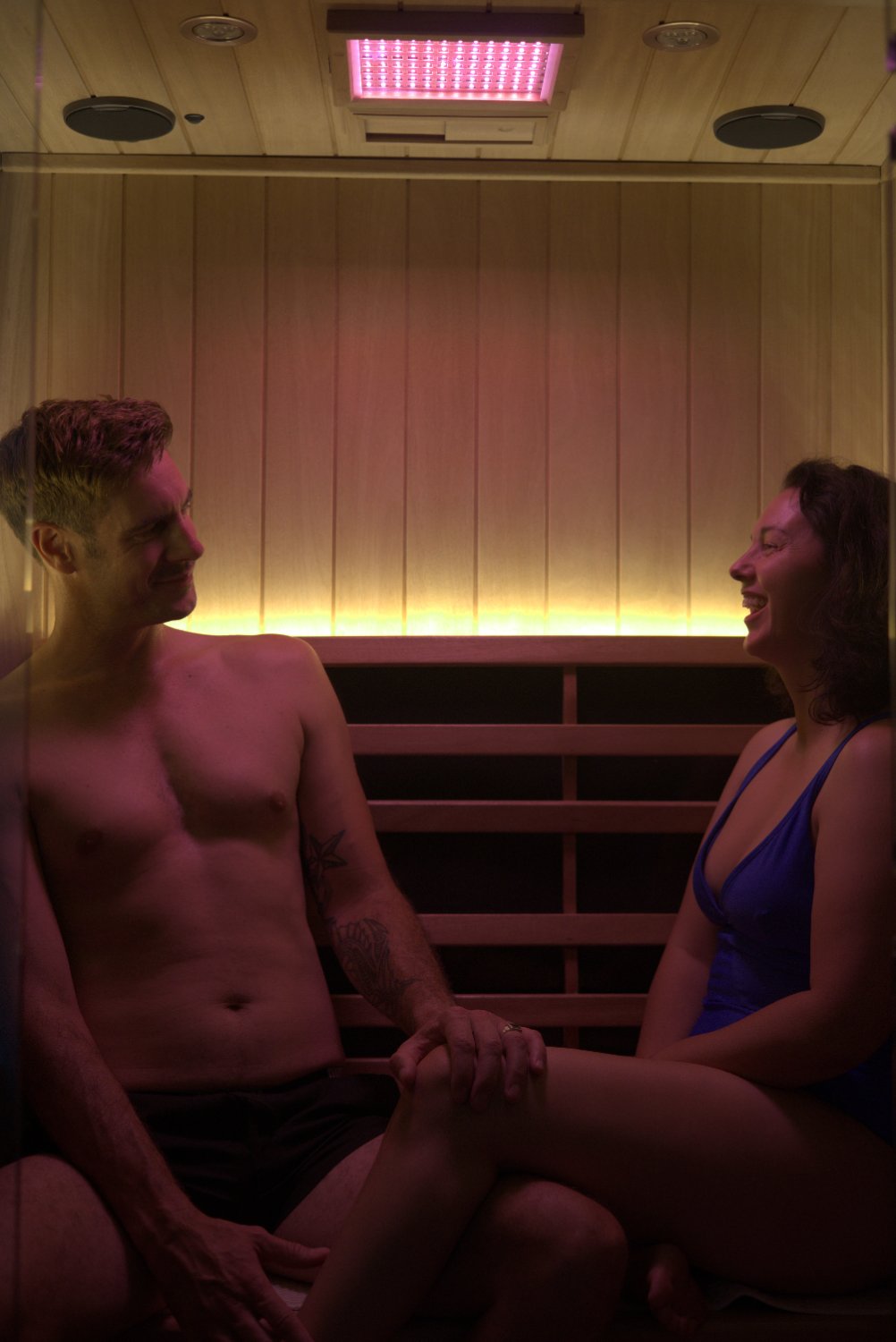 Couple laughing together inside the infrared sauna